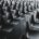 Large group of empty black chairs in a conference room